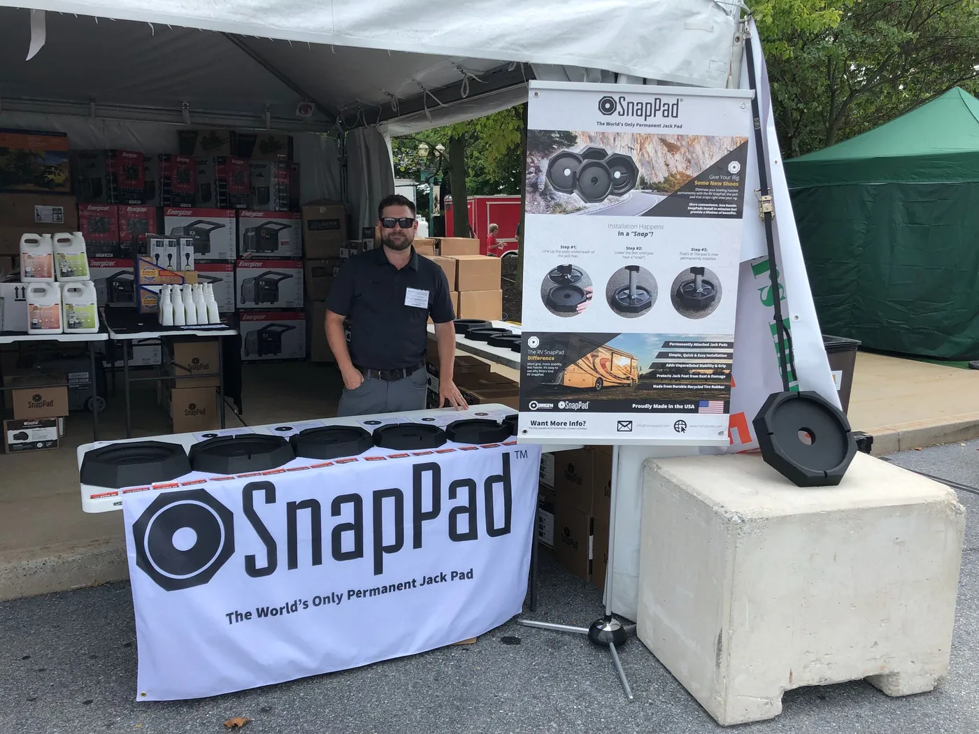 SnapPad booth with products and a team member under a tent at an RV show