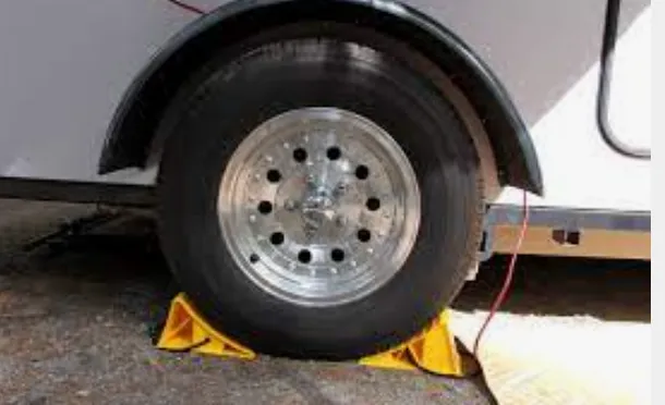 Trailer tire with a yellow wheel chock
